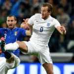 Giorgio Chiellini challenges Harry Kane for the ball