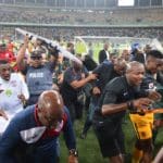 Players, staff and officials run into the stadium to get away from the fan violence at the Moses Mabida Stadium.