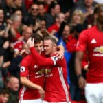 Josh Harrop celebrates his debut goal with Wayne Rooney