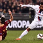 Alexandre Lacazette is challenged by Konstantinos Manolas