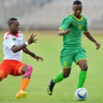Bukhosi Sibanda tackled by Boyd Musonda