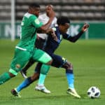 Percy Tau evades a challenge from Mlungisi Mbunjana