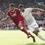 Marcus Rashford in action with Joseph Gomez