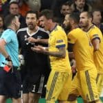 Referee Michael Oliver shows Juventus' goalkeeper Gianluigi Buffon the red card.