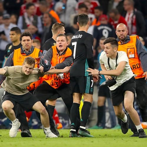 Uefa charges Bayern Munich over pitch invasion and banner