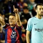 Barcelona midfielder Sergio Busquets looks on as Levante's Macedonian midfielder Enis Bardhi celebrates scoring.