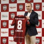 Spanish soccer player Andres Iniesta shows off his new jersey