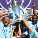 Manchester City's Vincent Kompany (left), Yaya Toure (second right) and Sergio Aguero lift the Premier League trophy.