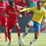 Lebohang Maboe of Mamelodi Sundowns challenges Innocent Maela of Orlando Pirates