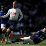 Spurs' Christian Eriksen evades a challenge from Cenk Tosun of Everton