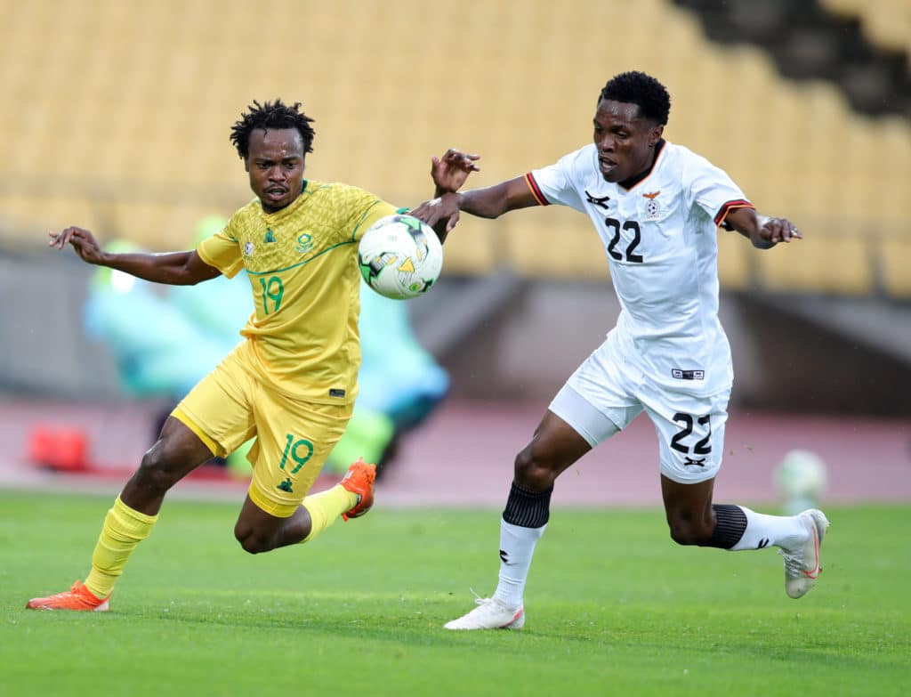 Percy Tau of South Africa challenged by Leonard Mulenga of Zambia during the international friendly match between South Africa and Zambia at Royal Bafokeng Stadium, Rustenburg, on 11 October 2020 ©Samuel Shivambu/BackpagePix