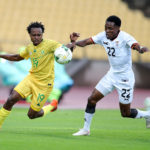 Percy Tau of South Africa challenged by Leonard Mulenga of Zambia during the international friendly match between South Africa and Zambia at Royal Bafokeng Stadium, Rustenburg, on 11 October 2020 ©Samuel Shivambu/BackpagePix