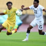 Percy Tau of South Africa challenged by Leonard Mulenga of Zambia during the international friendly match between South Africa and Zambia at Royal Bafokeng Stadium, Rustenburg, on 11 October 2020 ©Samuel Shivambu/BackpagePix