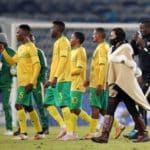 Helman Mkhalele, assistant coach of Bafana Bafana congratulates the players after victory over Uganda