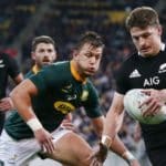 WELLINGTON, NEW ZEALAND - JULY 27: Beauden Barrett of the All Blacks looks to clear a kick against Handre Pollard of the Springboks during the 2019 Rugby Championship Test Match between New Zealand and South Africa at Westpac Stadium on July 27, 2019 in Wellington, New Zealand. (Photo by Anthony Au-Yeung/Getty Images)