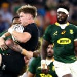 TOWNSVILLE, AUSTRALIA - SEPTEMBER 25: Jordie Barrett of the All Blacks is tackled during the Rugby Championship match between the New Zealand All Blacks and the South African Springboks at QCB Stadium on September 25, 2021 in Townsville, Australia. (Photo by Chris Hyde/Getty Images)