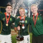 South Africa's Impi Visser, JC Pretorius, and Ryan Oosthuizen celebrate with the Cup trophy on day two of the Dubai Emirates Airline Rugby Sevens 2021 men's competition on 27 November, 2021. Photo credit: Mike Lee - KLC fotos for World Rugby/BackpagePix