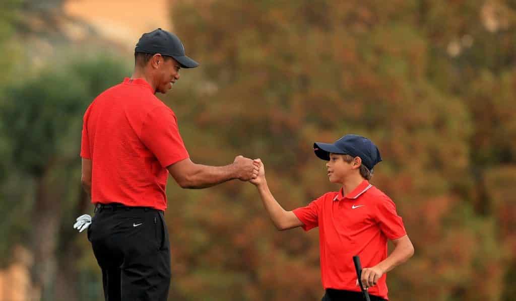 ORLANDO, FLORIDA - DECEMBER 20: Tiger Woods of the United States and son Charlie Woods fist bump on the 18th hole during the final round of the PNC Championship at the Ritz Carlton Golf Club on December 20, 2020 in Orlando, Florida. (Photo by Mike Ehrmann/Getty Images)