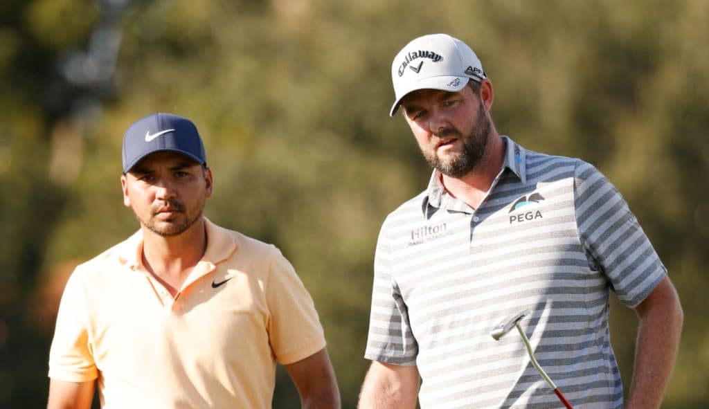 NAPLES, FLORIDA - DECEMBER 10: Jason Day of Australia and Marc Leishman of Australia react to a putt on the 17th green during the first round of the QBE Shootout at Tiburon Golf Club on December 10, 2021 in Naples, Florida. (Photo by Cliff Hawkins/Getty Images)