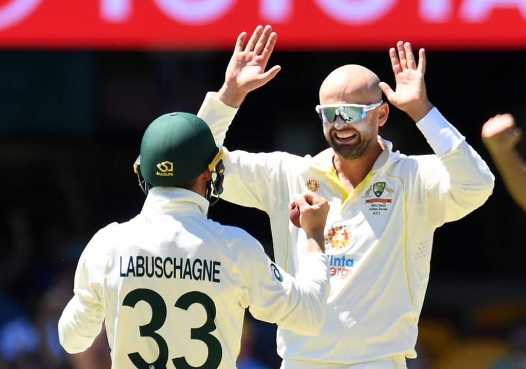 BRISBANE, AUSTRALIA - DECEMBER 11: Nathan Lyon of Australia celebrates dismissing Dawid Malan of England during day four of the First Test Match in the Ashes series between Australia and England at The Gabba on December 11, 2021 in Brisbane, Australia. (Photo by Albert Perez - CA/Cricket Australia via Getty Images)
