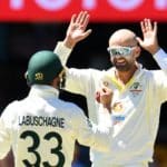 BRISBANE, AUSTRALIA - DECEMBER 11: Nathan Lyon of Australia celebrates dismissing Dawid Malan of England during day four of the First Test Match in the Ashes series between Australia and England at The Gabba on December 11, 2021 in Brisbane, Australia. (Photo by Albert Perez - CA/Cricket Australia via Getty Images)