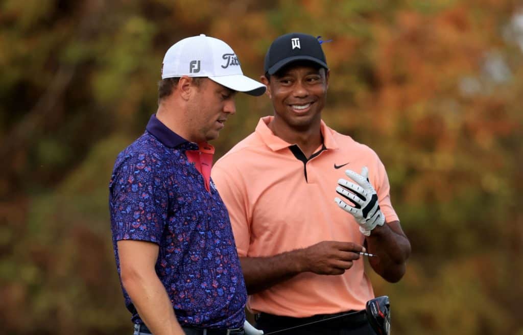 ORLANDO, FLORIDA - DECEMBER 18: Tiger Woods and Justin Thomas wait on the 18th hole during the first round of the PNC Championship at the Ritz Carlton Golf Club Grande Lakes on December 18, 2021 in Orlando, Florida. (Photo by Sam Greenwood/Getty Images)