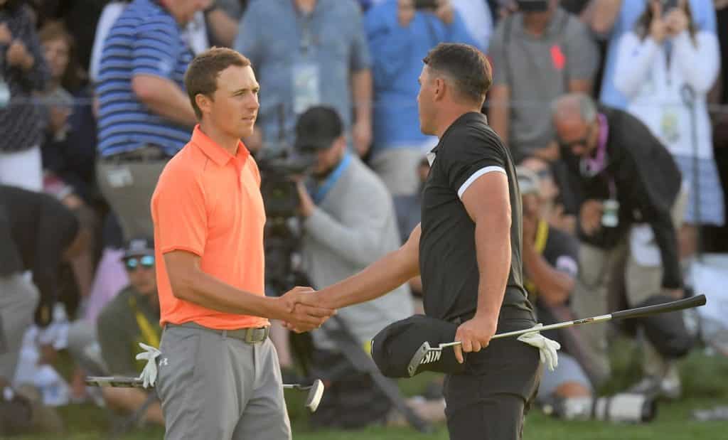 FARMINGDALE, NEW YORK - MAY 18: Jordan Spieth of the United States and Brooks Koepka of the United States shake hands on the 18th green during the third round of the 2019 PGA Championship at the Bethpage Black course on May 18, 2019 in Farmingdale, New York. (Photo by Ross Kinnaird/Getty Images)