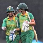 South Africa's Mignon du Preez (L) and Marizanne Kapp walk from the field as the rain falls during the Women's Cricket World Cup match between the West Indies and South Africa at the Basin Reserve in Wellington on March 24, 2022. (Photo by Marty MELVILLE / AFP) (Photo by MARTY MELVILLE/AFP via Getty Images)