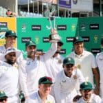 South Africa's Dean Elgar (C) holds the trophy as the South African team poses for a photo after winning the series following the second Test cricket match between South Africa and Bangladesh at St George's Park in Gqeberha on April 11, 2022. (Photo by Marco LONGARI / AFP) (Photo by MARCO LONGARI/AFP via Getty Images)