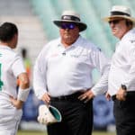 South Africa's Dean Elgar (L) talks to South African umpire Marais Erasmus (C) and South African umpire Adrian Holdstock during the delay of the start of the first day of the first Test cricket match between South Africa and Bangladesh at the Kingsmead stadium in Durban on March 31, 2022. (Photo by Marco Longari / AFP) (Photo by MARCO LONGARI/AFP via Getty Images)