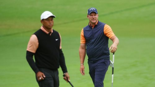 TULSA, OKLAHOMA - MAY 21: Tiger Woods of the United States and Shaun Norris of South Africa prepare to putt on the fourth green during the third round of the 2022 PGA Championship at Southern Hills Country Club on May 21, 2022 in Tulsa, Oklahoma. (Photo by Andrew Redington/Getty Images)