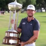 FORT WORTH, TEXAS - MAY 29: Sam Burns of the United States poses with the Leonard Trophy after putting in to win on the 18th green during the first playoff hole during the final round of the Charles Schwab Challenge at Colonial Country Club on May 29, 2022 in Fort Worth, Texas. (Photo by Tom Pennington/Getty Images)