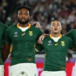 YOKOHAMA, JAPAN - NOVEMBER 02: (L-R) Damian de Allende, Lukhanyo Am, Cheslin Kolbe, Willie Le Roux, Makazole Mapimpi, Steven Kitshoff and Malcolm Marx of South Africa participate in the South African national anthem prior to the Rugby World Cup 2019 Final between England and South Africa at International Stadium Yokohama on November 02, 2019 in Yokohama, Kanagawa, Japan. (Photo by Cameron Spencer/Getty Images)