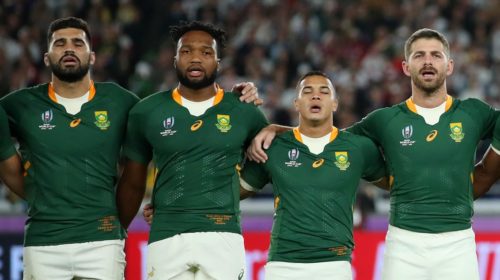 YOKOHAMA, JAPAN - NOVEMBER 02: (L-R) Damian de Allende, Lukhanyo Am, Cheslin Kolbe, Willie Le Roux, Makazole Mapimpi, Steven Kitshoff and Malcolm Marx of South Africa participate in the South African national anthem prior to the Rugby World Cup 2019 Final between England and South Africa at International Stadium Yokohama on November 02, 2019 in Yokohama, Kanagawa, Japan. (Photo by Cameron Spencer/Getty Images)