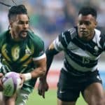 COVENTRY, ENGLAND - JULY 31: Selvyn Davids of Team South Africa goes past Vuiviwa Naduvalo of Team Fiji during the Men's Rugby Sevens Gold Medal Match between Team Fiji and Team South Africa on day three of the Birmingham 2022 Commonwealth Games at Coventry Stadium on July 31, 2022 on the Coventry, England. (Photo by David Rogers/Getty Images)